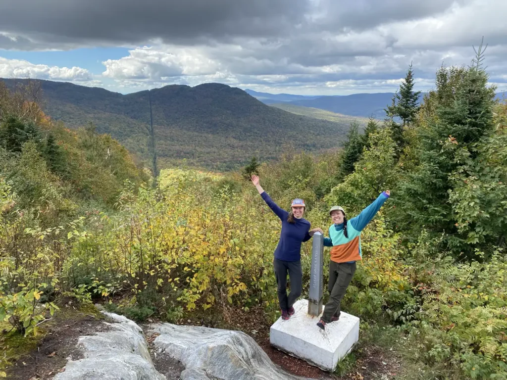 hikers standing on marker