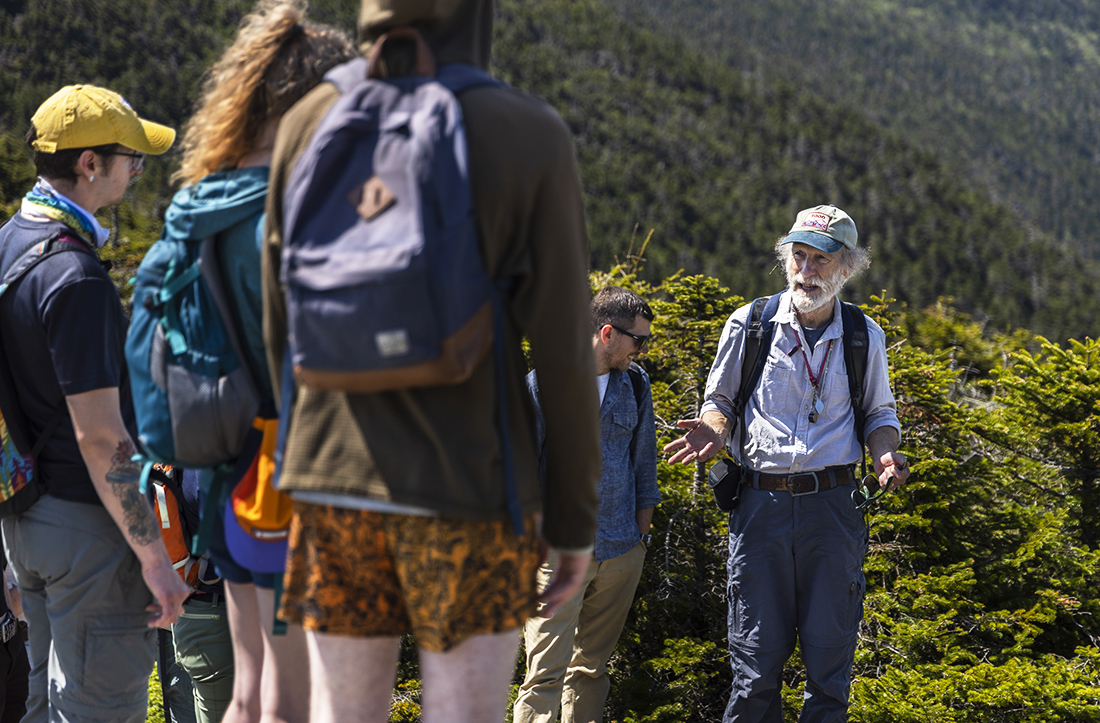 Bob Popp, retired Vermont State Biologist, points out different alpine plants to caretakers during the 2023 alpine ecology training walk on Mt. Mansfield.