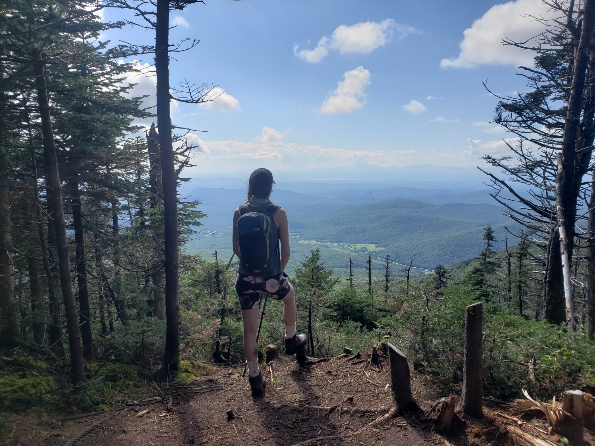 a hiker gazes out over the westerly facing view on the Monroe Skyline hike