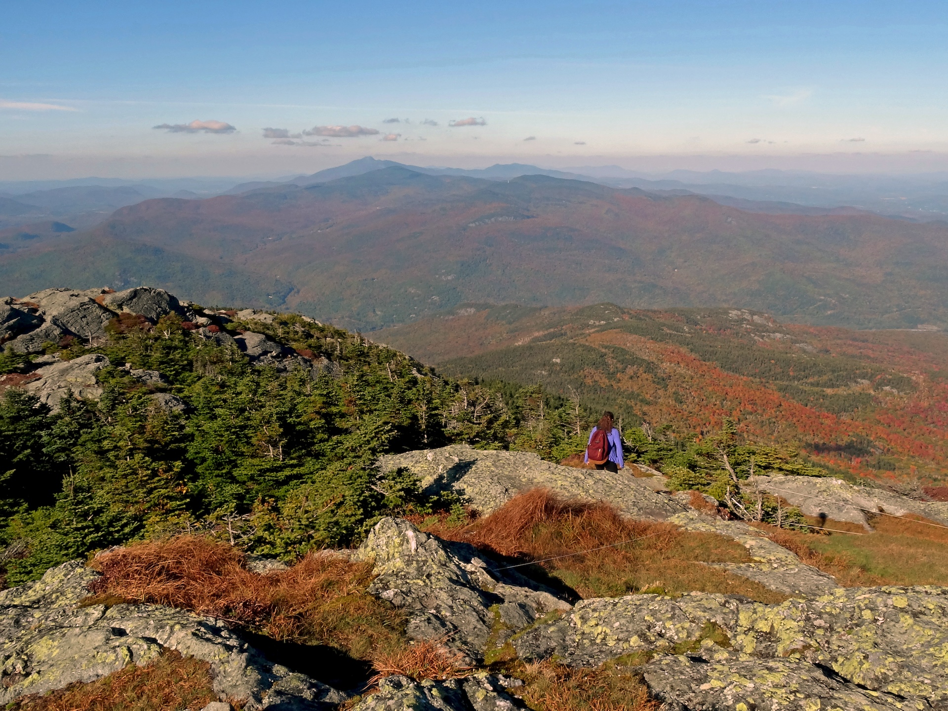 view over rocky summit with orange foliage