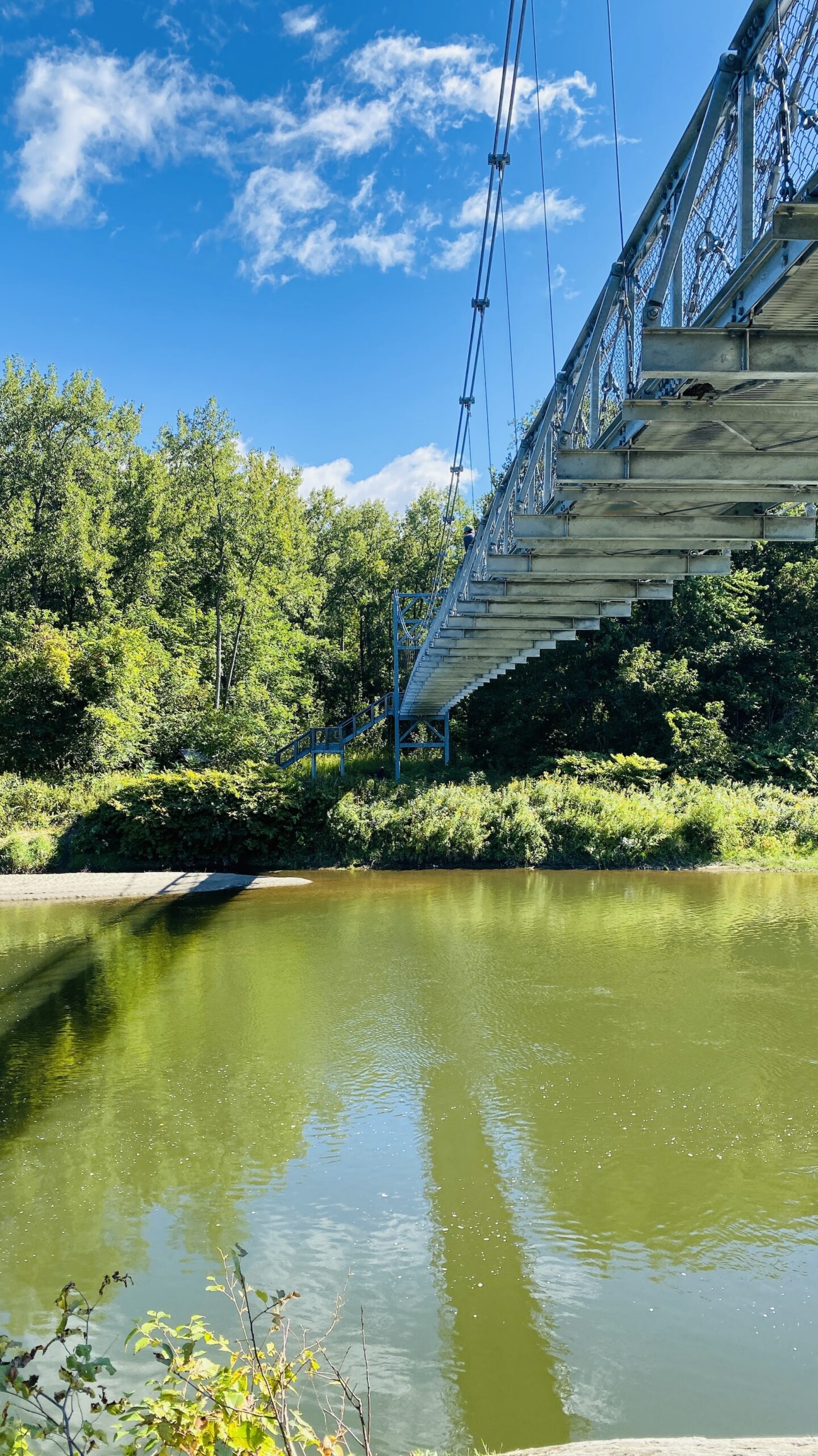 view of Winooski River and footbridge in summer