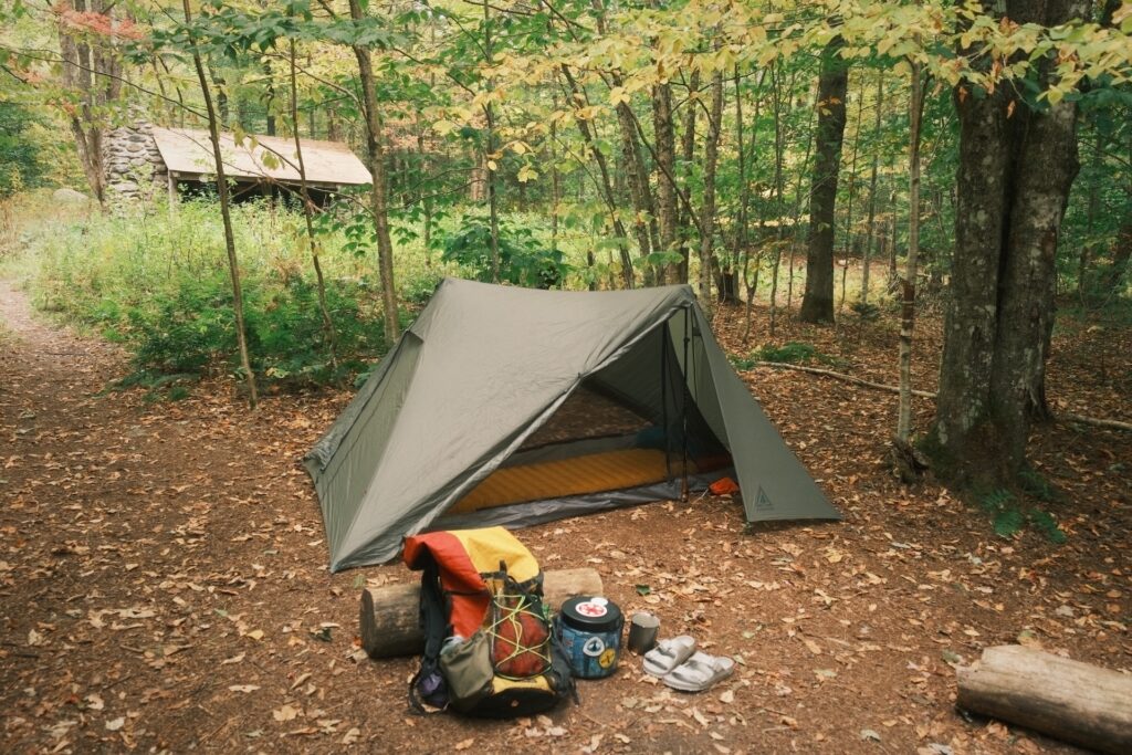 Allen Smith_E2E2025_20250917_backpack_bear canister_gov_clement_tenting a tent with backpack and bear canister out front