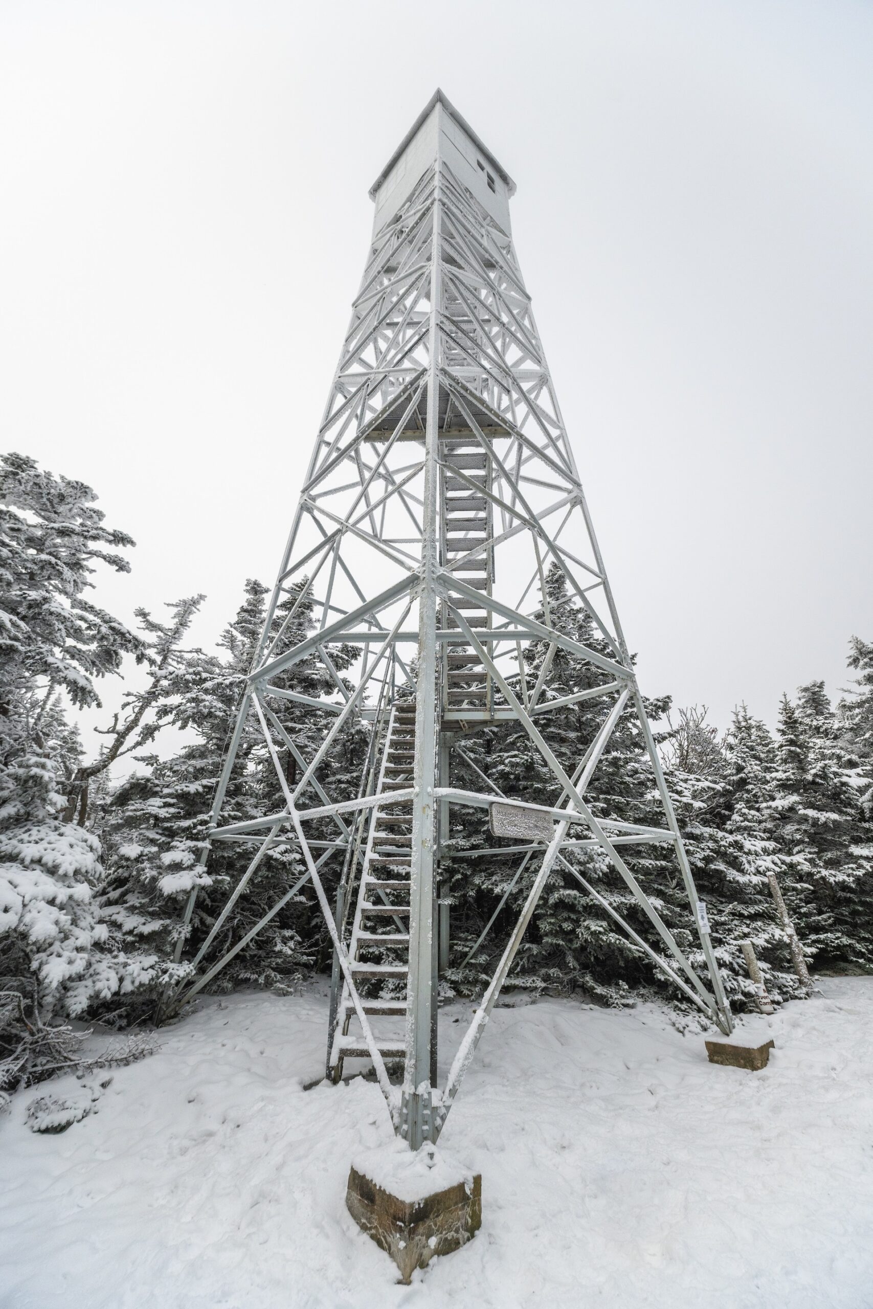 fire tower covered in snow and ice on a mountaintop